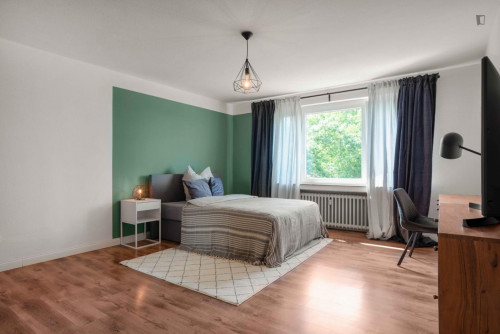 Bright and spacious double bedroom with TV
