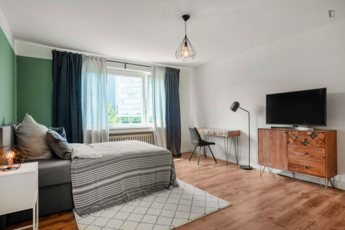 Bright and spacious double bedroom with TV