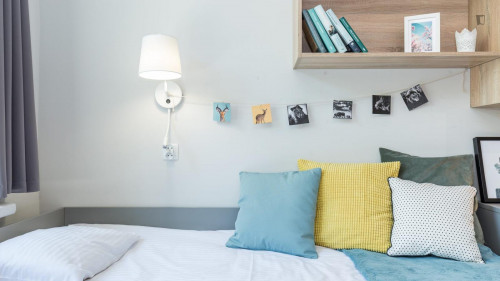 Bed in a cosy twin bedroom in a student residence, in the Płaszów area