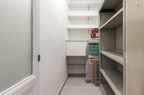 Large single bedroom with window to an interior patio in Barcelona