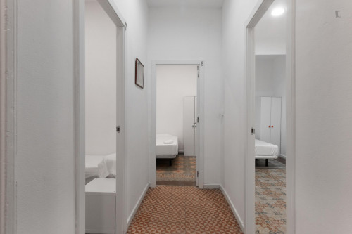 Large single bedroom with window to an interior patio in Barcelona