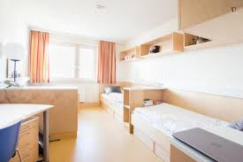 Bed in a twin bedroom, part of a flat in a residence in Liesing