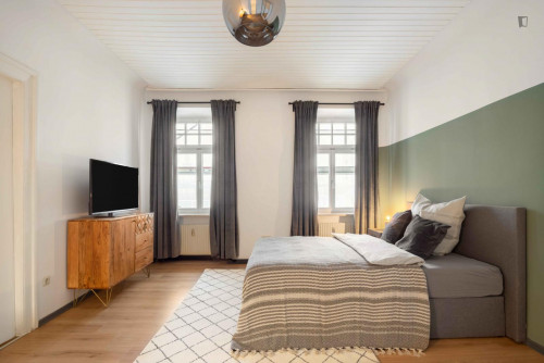 Spacious single bedroom with TV in a 3-bedroom apartment