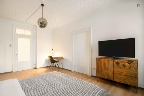 Spacious single bedroom with TV in a 3-bedroom apartment