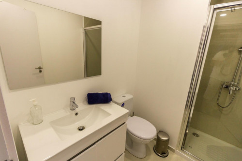 Design bedroom with a double bed and share bathroom