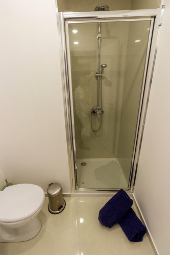 Design bedroom with a double bed and share bathroom