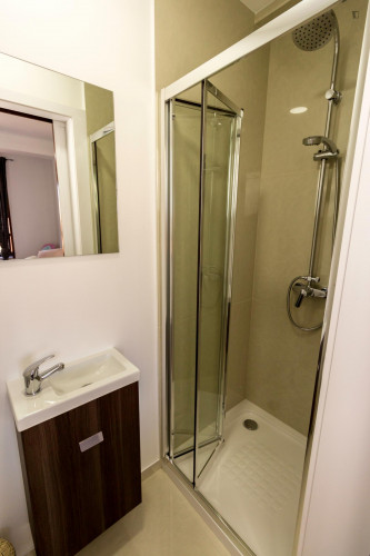Design bedroom with a double bed and share bathroom