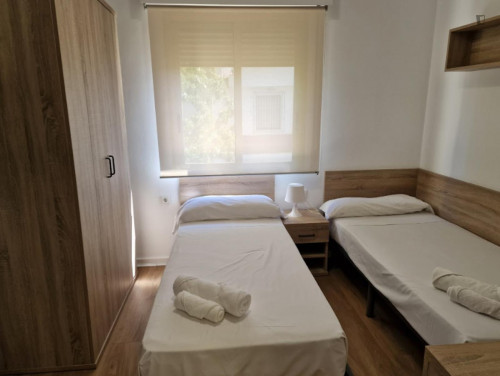 Bed in a cosy twin bedroom, in Bami