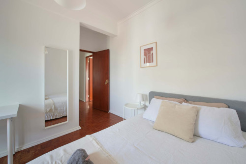 Comfortable bedroom with private balcony in a 5-bedroom apartment in Rua Eugénio de Castro - Room 4