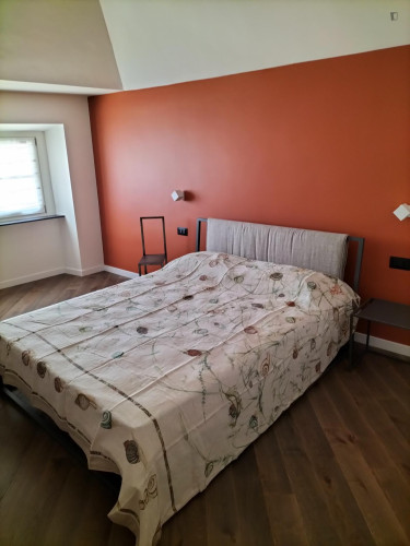 Comfortable double bedroom with private bathroom in a modern apartment