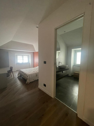Comfortable double bedroom with private bathroom in a modern apartment