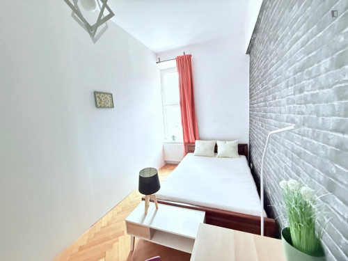 Sunny bedroom with a big bed in the center