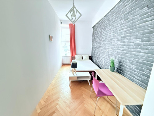 Sunny bedroom with a big bed in the center