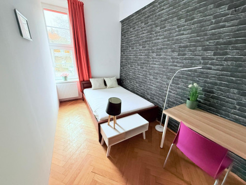 Sunny bedroom with a big bed in the center
