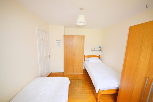 Bed in a cosy twin female bedroom