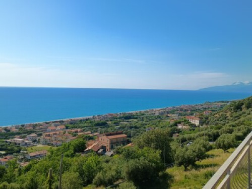 a sunny house in front of the sea
