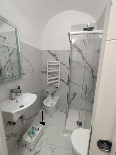 Bed in an ensuite twin bedroom with balcony in spacious apartment in the city center