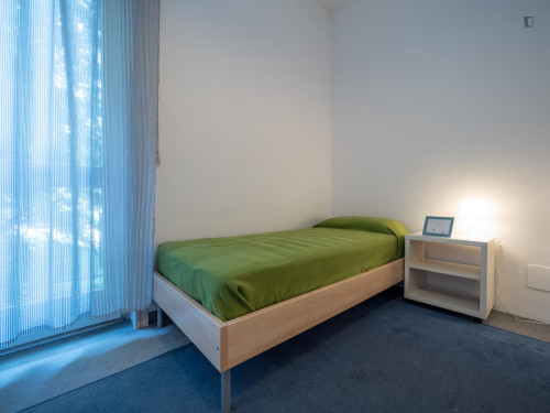 Bed in neat twin bedroom near Bocconi University