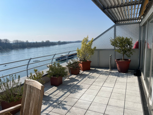 A penthouse feel across 104 m² with a 35 m² south-facing roof terrace and views of the Rhine