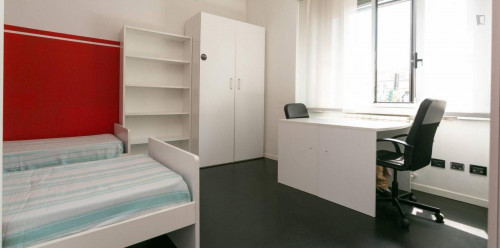 Bed in a twin bedroom close to NABA