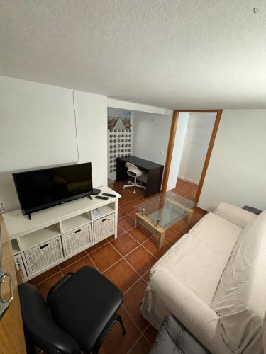 Comfy bedroom with a private bathroom and a small kitchen