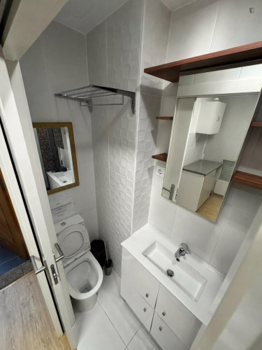 Comfy bedroom with a private bathroom and a small kitchen